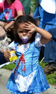 Zayonna Ayer, 3, from Camden, watches the parade during Saturday's Oz-Stravaganza in Chittenango. Photo by Brian McDowell