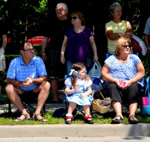 3-year-old Izzy King, from New Hartford, watches the parade dressed as Dorothy. She was sitting with her grandparents, Tony and Ann King, during Saturday's Oz-Stravaganza parade in Chittenango. Photo by Brian McDowell