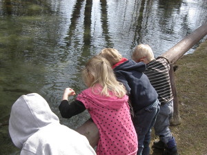 Young visitors enjoy the return of spring while feeding trout at Rogers Center. Clyde’s Little Red Barn will sponsor a special Spring Bingo Family Fun program, hosted by Friends of Rogers, on March 19. Photo courtesy Friends of Rogers