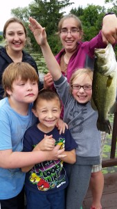 Young anglers pose with a fish caught at Rogers Center last year. Join Friends of Rogers for the third annual free Family Fishing Day on June 18. Photo courtesy Friends of Rogers