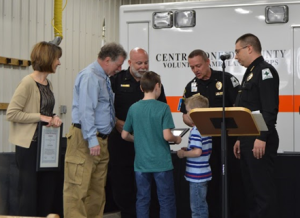 Bryan Hill presents the Life Saving Award to Clinton High School nurse Mary Beth King and the family of Jace Janczewski.  In August of 2015, Mary Beth King and the COCVAC crew provided CPR and other life-saving interventions to Bryan Hill, after he collapsed at Clinton High School.  In typical EMS fashion, Jace Janczewski was not available to receive the award due to being on an EMS call.