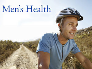 Portrait of handsome man wearing helmet riding bike in countryside