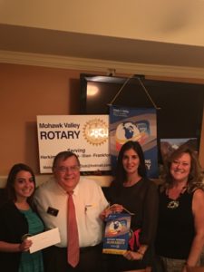 Pictured from left, Club Treasurer Elyse Enea presents District Governor Peter Cardamone with a donation to Rotary’s Fight to End Polio Now, Club President Heather Irons and Club President Elect Cindy Bennett.