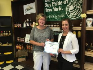 Greater Oneida Chamber of Commerce treasurer, Rachel Siderine presents Elise Allen of Oneida Commons Vendor Mall with Business of the Month award.