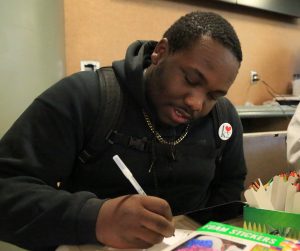 Justin Gibson makes cards for military troops. The cards will be sent to active troops as well as those who are hospitalized.  Photo by Ken Chapman, New Media Strategist.