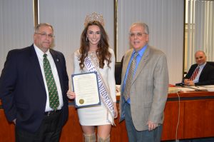Corrin Stellakis (center), Miss Earth United States 2016, was presented with a Proclamation from the Madison County Board of Supervisors by Chairman John Becker (left) for being named Miss Earth United States 2016 and for her exceptional talent and dedication as an environmental advocate. James Zecca, Director of the Dept. of Solid Waste and Sanitation, was also on hand for the presentation.