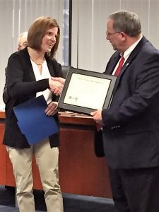 Wendy Hunt, program manager for the Oneida County Cancer Services Program, presents Chairman John M. Becker with the Cancer Screening Championship Award.